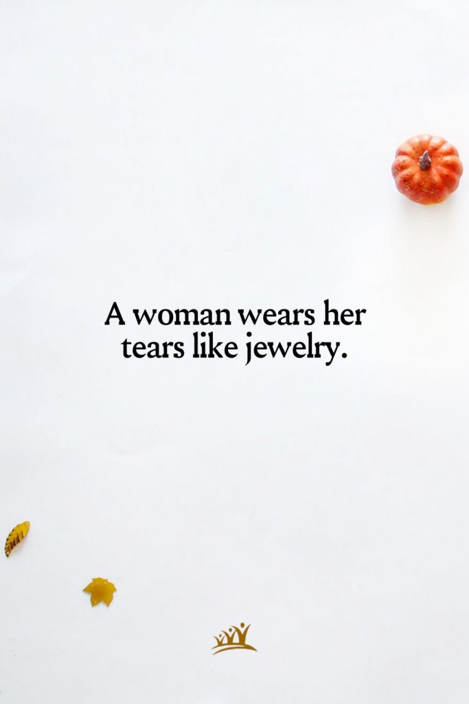 A woman wears her tears like jewelry.