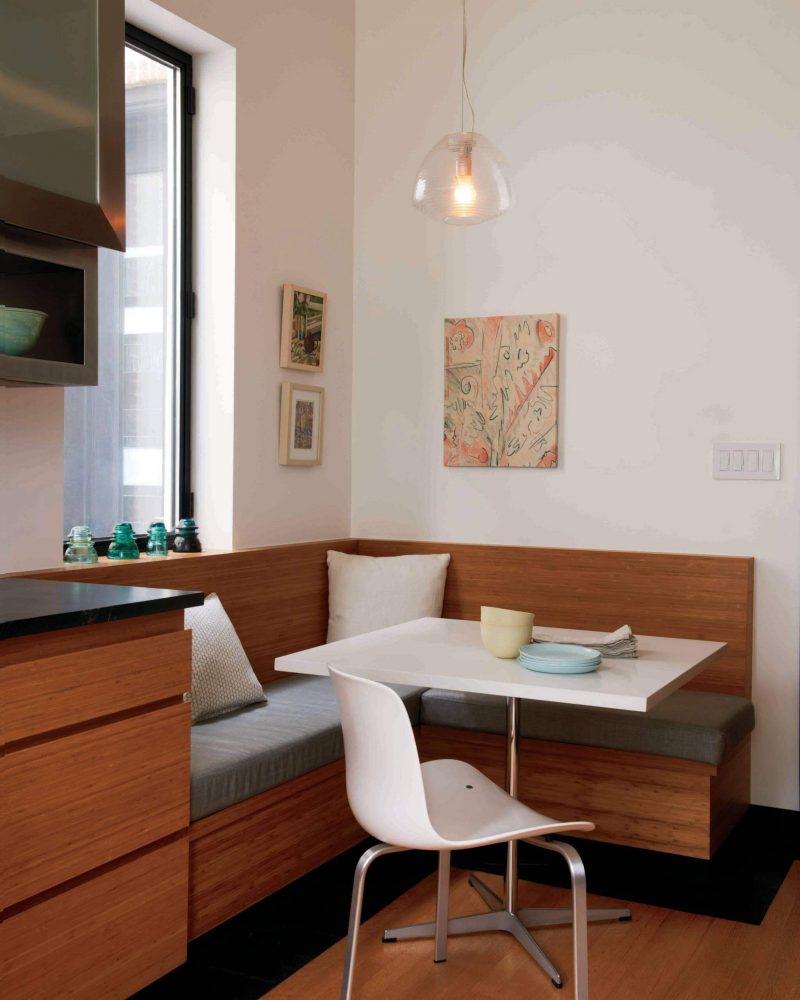 A banquette made from the same wood used for the kitchen cabinets makes for a well blended breakfast area