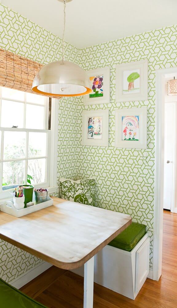 A butcher block table supported by a single leg and a pendant light from Arteriors are highlights of this Cristin Priest designed breakfast nook