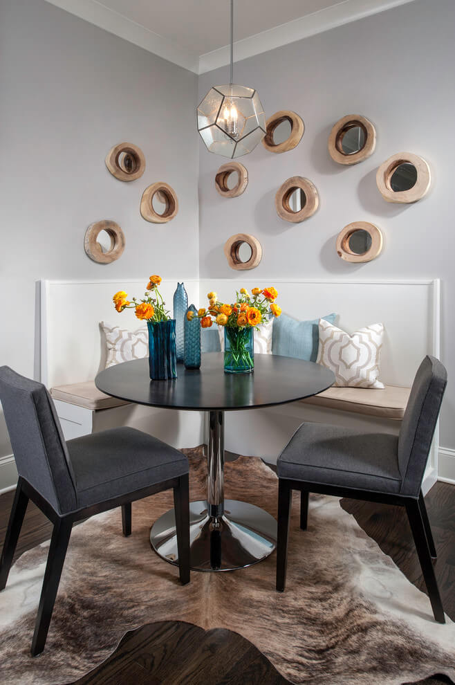 A collection of rustic round mirrors and a hide rug are among the features of this kitchen eating area in Chicago