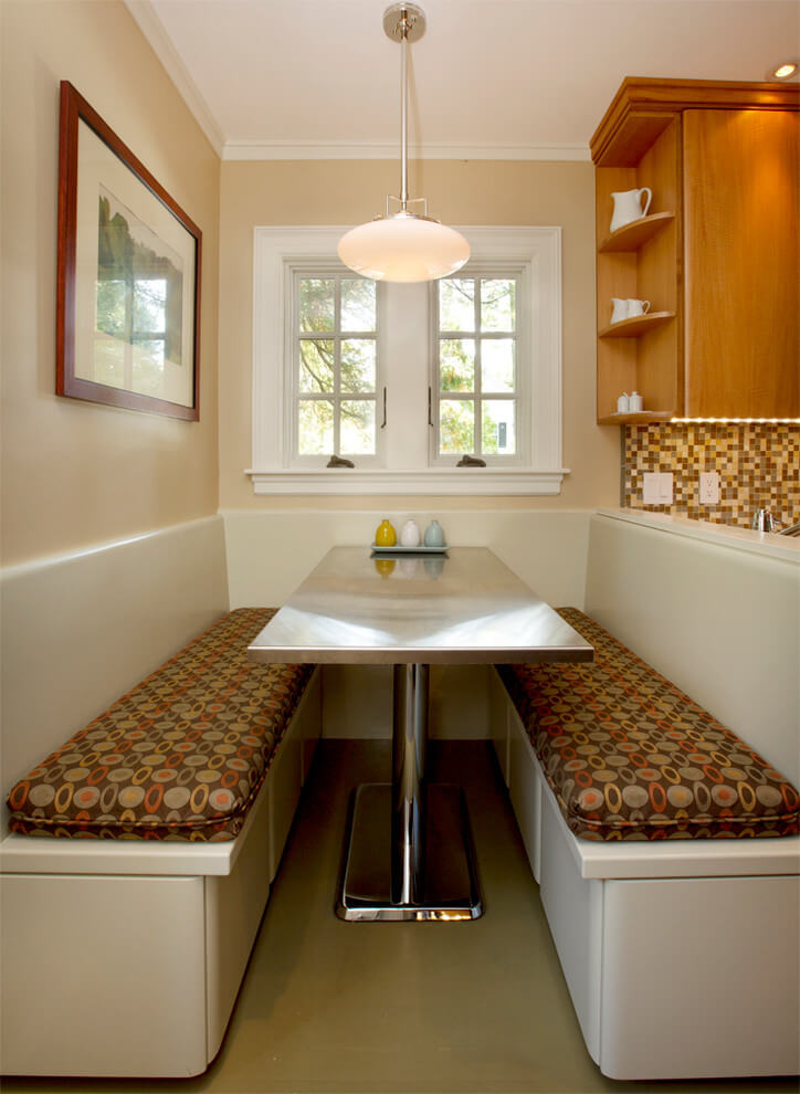 A custom built banquette in Boston has retro appeal with its chrome table and patterned fabric bench seats.