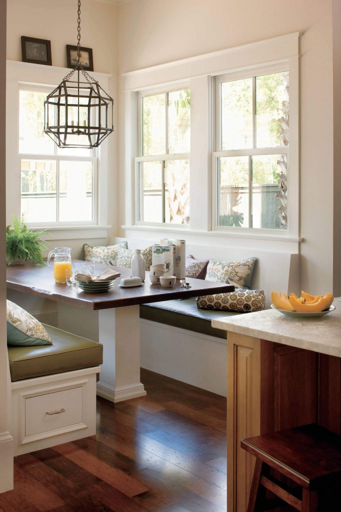 A cypress wood tabletop, walnut floors and a Morris hanging lantern are among the highlights of this New Orleans breakfast area designed by Jackson Cabinetry