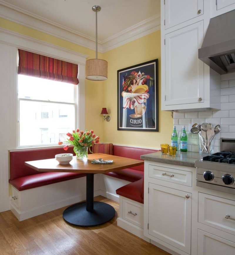 A red leather banquette, sea green limestone countertops and yellow walls make for a bright kitchen corner in San Francisco’s Sea Cliff neighborhood