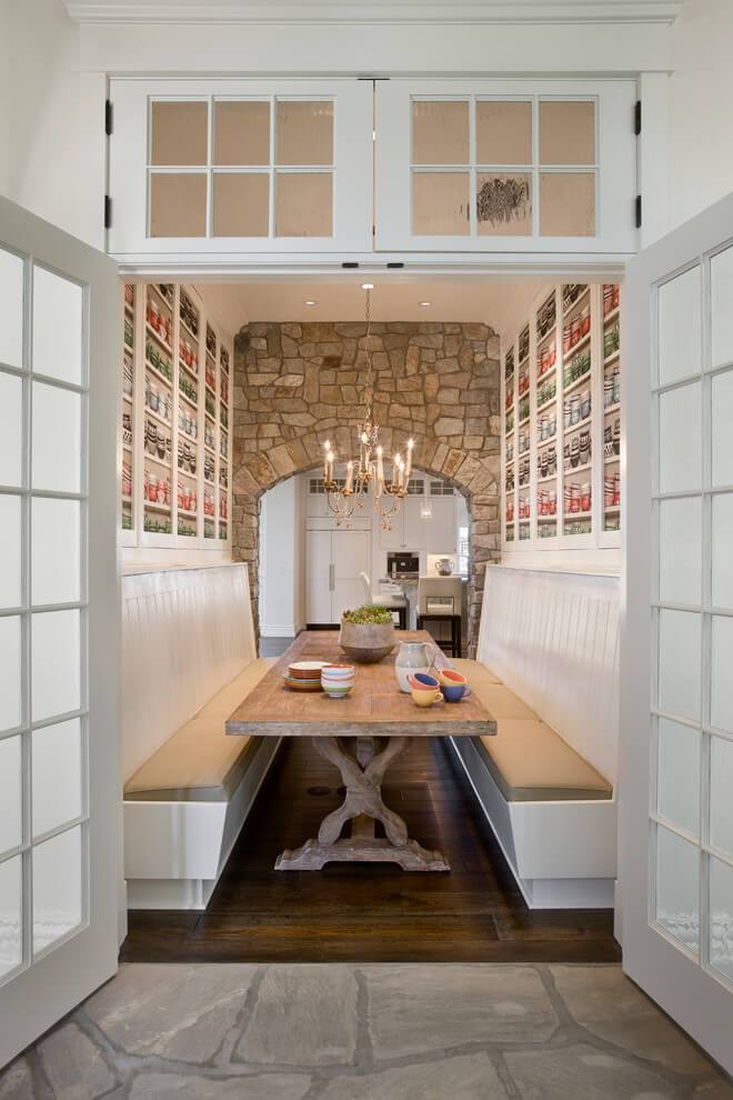 A set of French doors leads to a flagstone patio on the opposite side of this custom breakfast banquette in Orlando, Florida