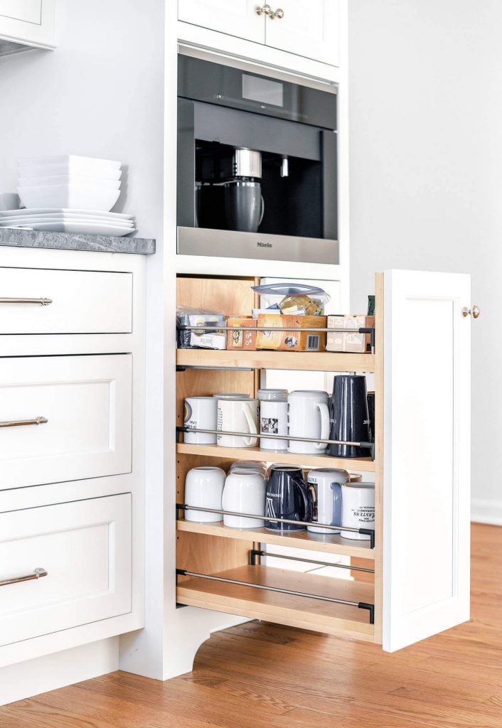 The custom pullout drawer below the built-in coffeemaker in this Philadelphia kitchen was added to store a collection of coffee mugs. Space is by Jarrett Design.