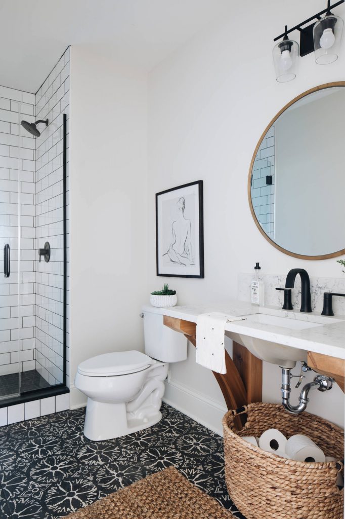 Country subway tile black floor alcove shower photo in Chicago with open cabinets, white walls, an undermount sink, a hinged shower door and white countertops