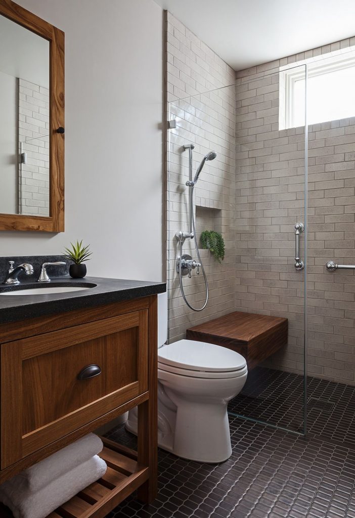 Example of a trendy black floor bathroom design in Orange County with flat panel cabinets, medium tone wood cabinets, an undermount sink and beige countertops