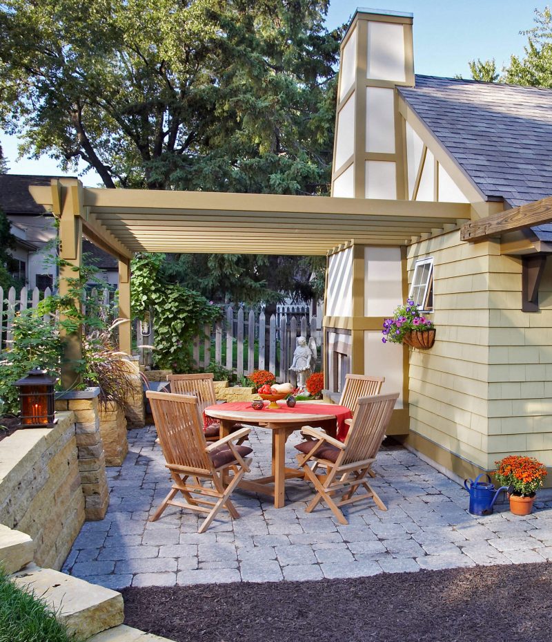 Inspiration for a small timeless backyard brick patio remodel in Minneapolis with a fire pit and a roof extension