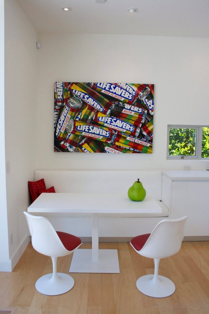 Peter and Madeline Powell created the Lifesaver inspired art for this modern all white kitchen in Tiburon, California