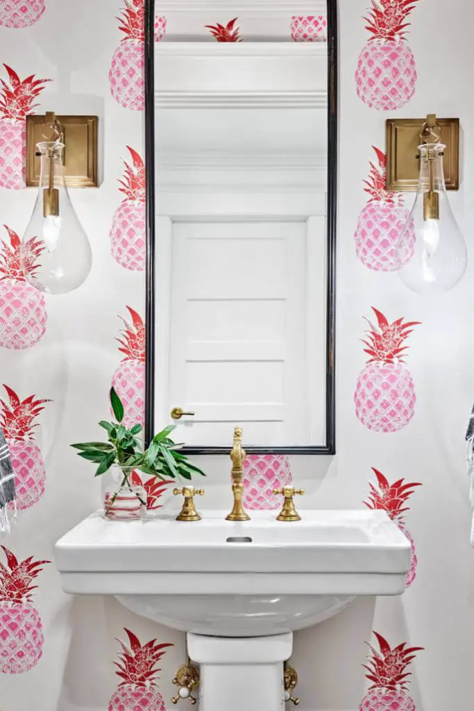 McKeithan Design Studio used bold pineapple-inspired wallpaper to make a splash in this Nashville, Tennessee, powder room.