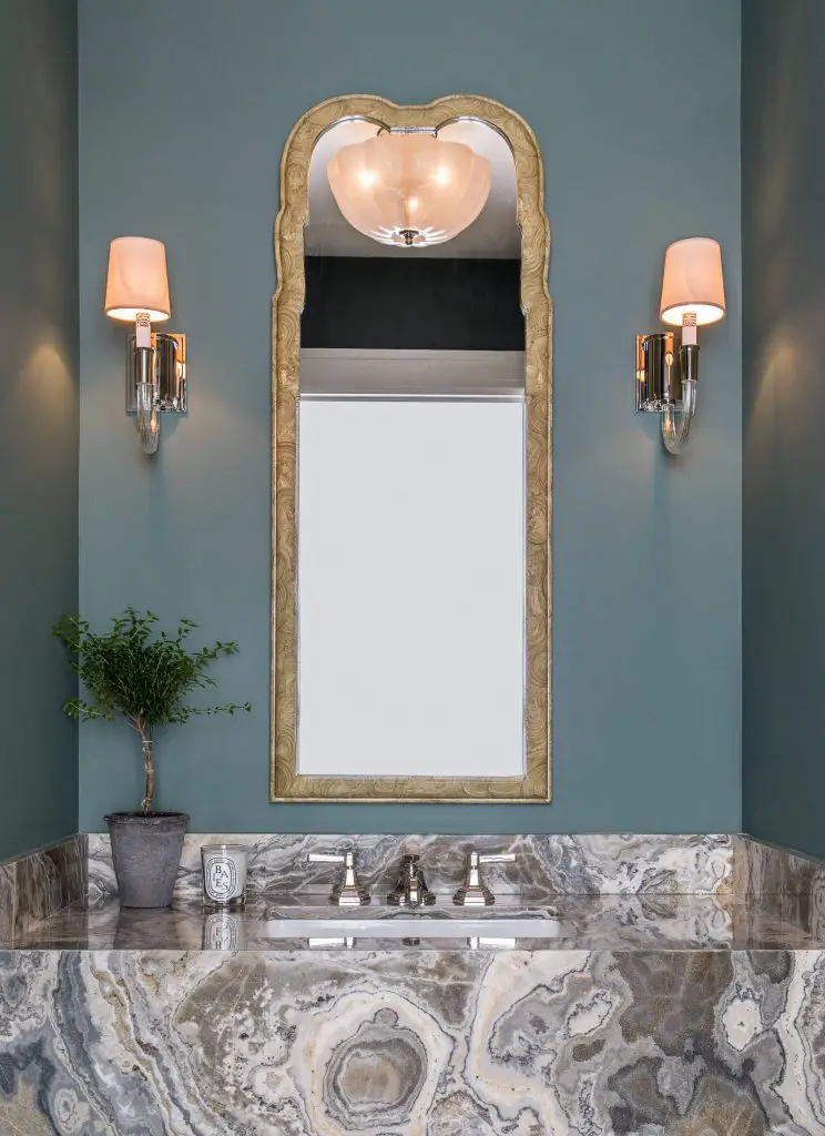 The multihued stone vanity in this Denver powder room by Emily Tucker Design is a stunner. Lovely blue-green painted walls add another layer of interest.