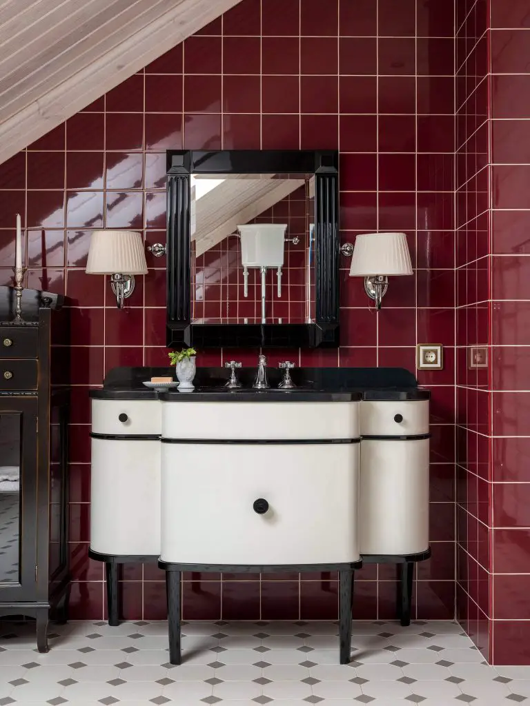 This Art Deco-inspired powder room in Moscow was designed by Natalya Vasilyeva. Space features a custom black-and-white vanity with a curvy silhouette.