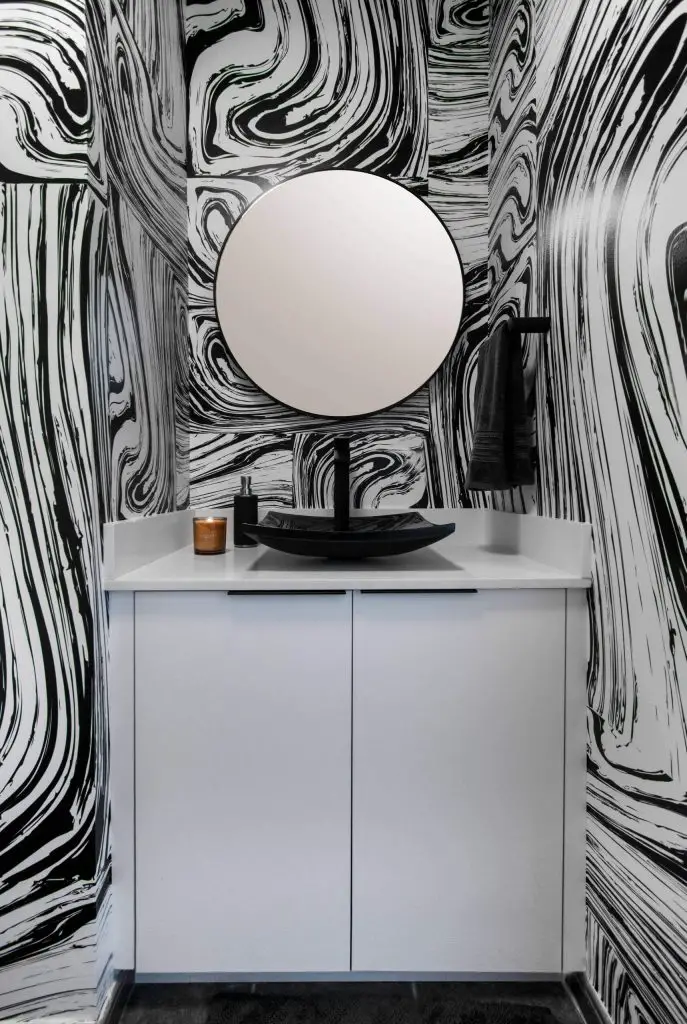 While this Miami powder room has a stark black-and-white color palette, it would be hard to describe the energetic space as minimalist.