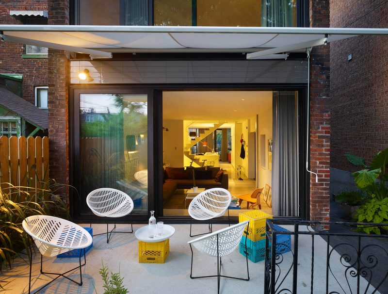 Small trendy backyard concrete patio photo in Toronto with an awning