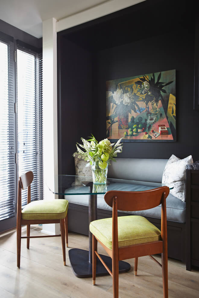 The black alcove wall provides a great contrast to the yellow cushioned dining chairs of this Toronto kitchen nook