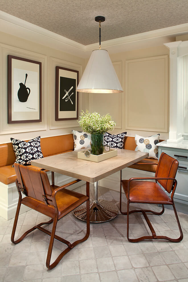 The cream paneled walls, leather covered banquette and leather strap chairs make for a handsome breakfast nook in Manhattan