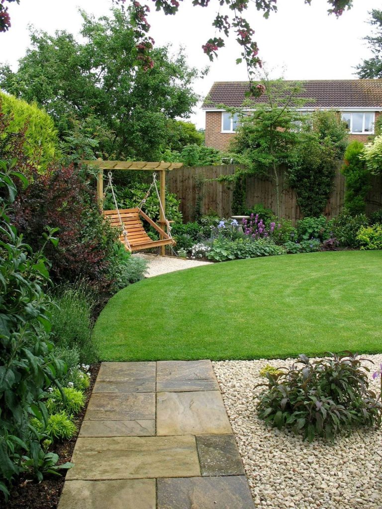 The new lawn makes the garden seem bigger and deeper. It's a shallow garden with a point to the left, now concealed by trees and the swing seat. New planting contrasts purples, greys and greens.