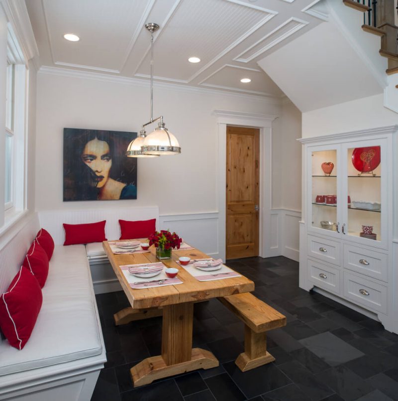 This breakfast area in Houston includes slate floors and a glass and chrome ceiling fixture from Restoration Hardware