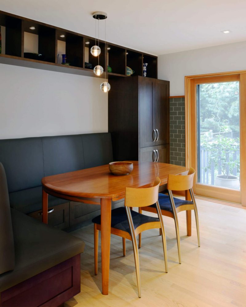 This contemporary Ottawa, Ontario, kitchen banquette created by Design First Interiors features a Bocci suspension lamp