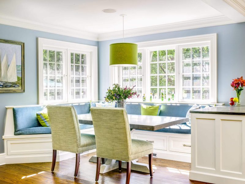 This sunny dining nook invites you in with its light blue, green, and cream hues