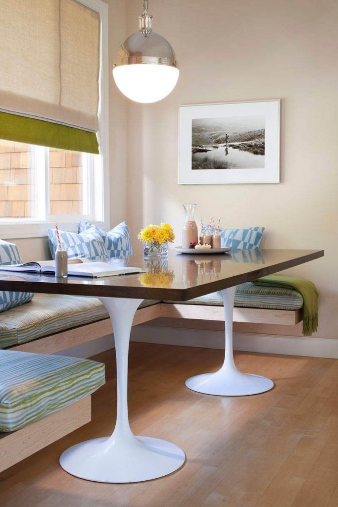 Two white Knoll bases were topped with a custom wood table to create this bright breakfast nook in San Francisco