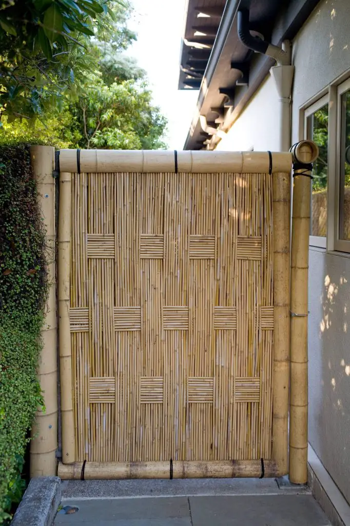A bamboo gate over bluestone paving conceals a Japanese meditation garden in San Francisco.