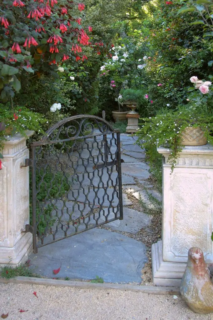 A classic iron gate leads to this French inspired garden in Santa Barbara