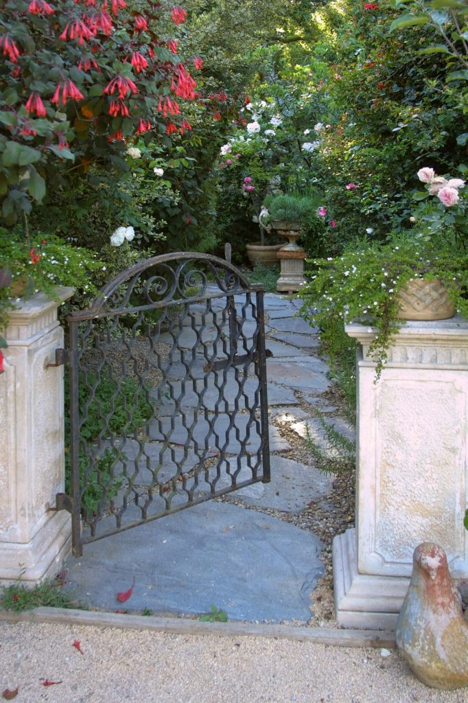 A classic iron gate leads to this French inspired garden in Santa Barbara