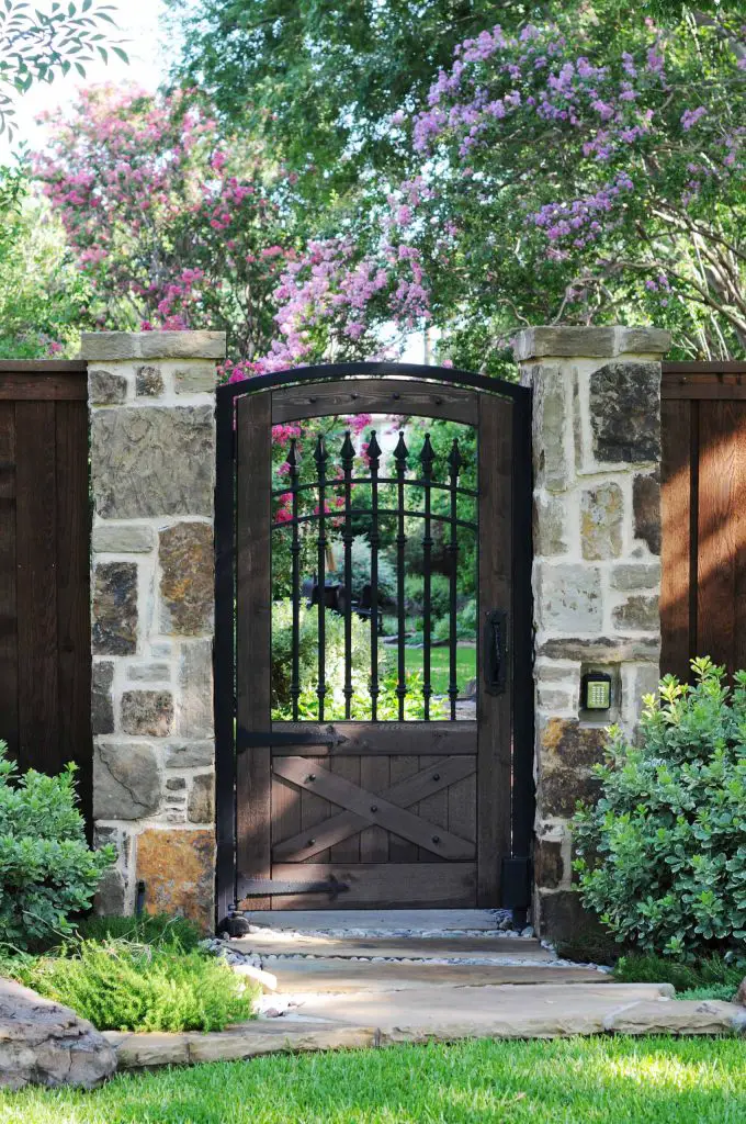 A mix of Colorado and Oklahoma stone was used to create the pillars framing the 7 foot gate leading to this Dallas garden.