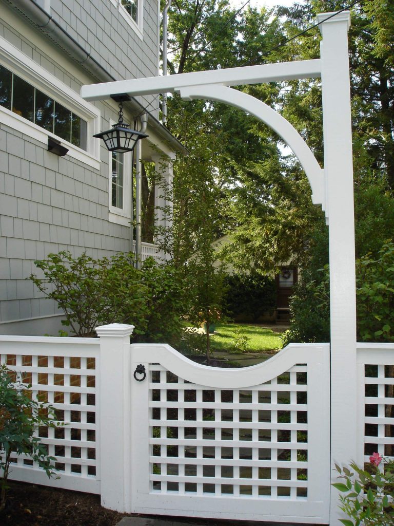 A pathway of brick and Sydney Peak flagstone leads to this white trellised garden gate near San Diego.