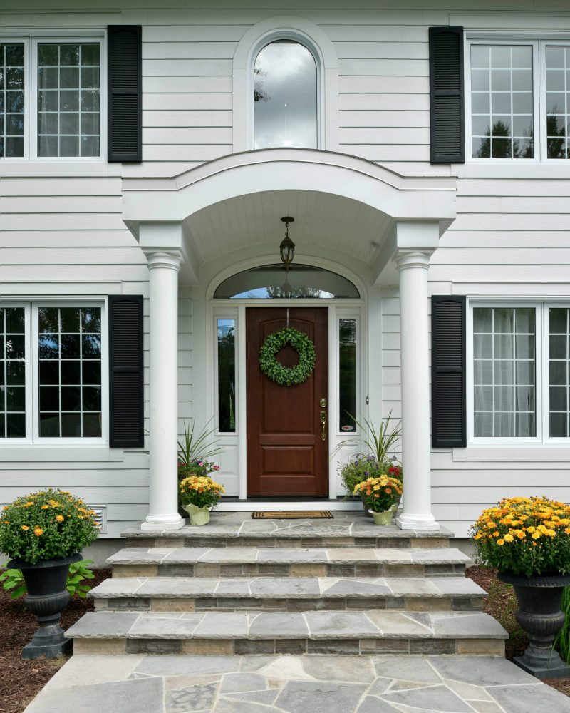 A plain green boxwood wreath makes the transition from fall to winter.