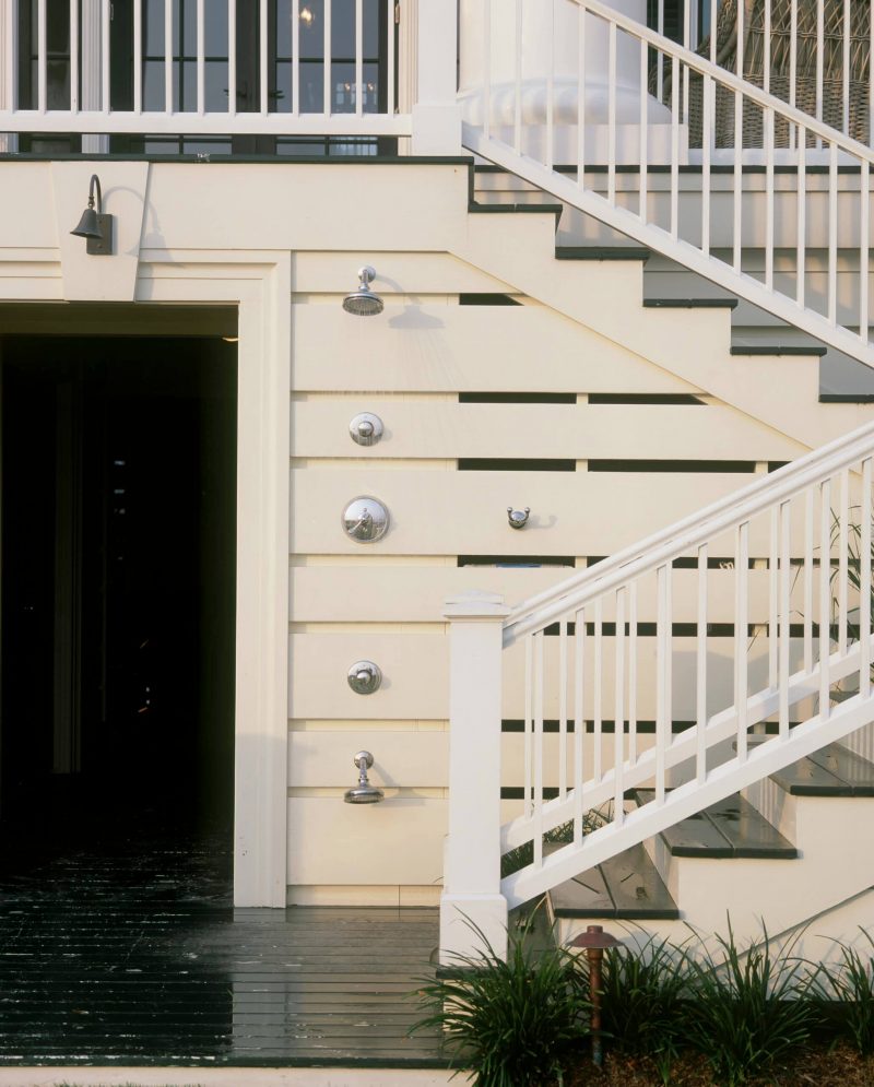 A shower on this exterior features two shower heads