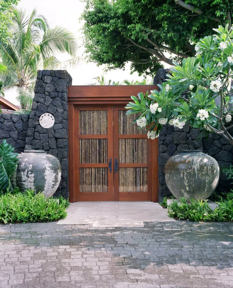 Bamboo doors and lava stone walls create a tropical paradise on this Hawaii garden estate.