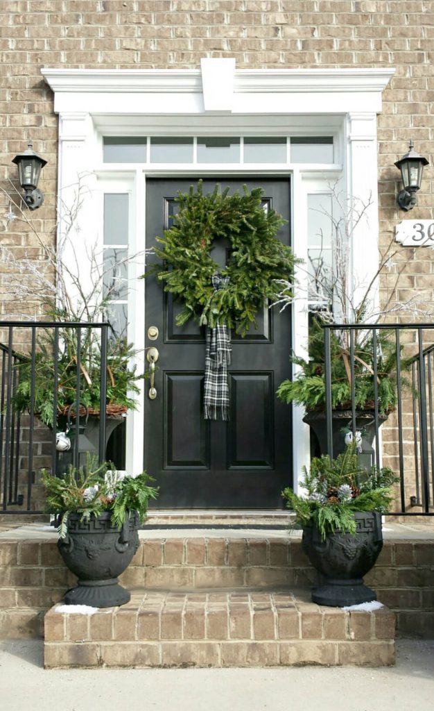 Black, white and green create a sophisticated entry here. And note that the wreath’s “bow” is actually a plaid scarf.