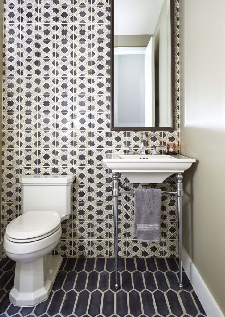 Example of a transitional black and white tile black floor powder room design in Phoenix with gray walls and a console sink