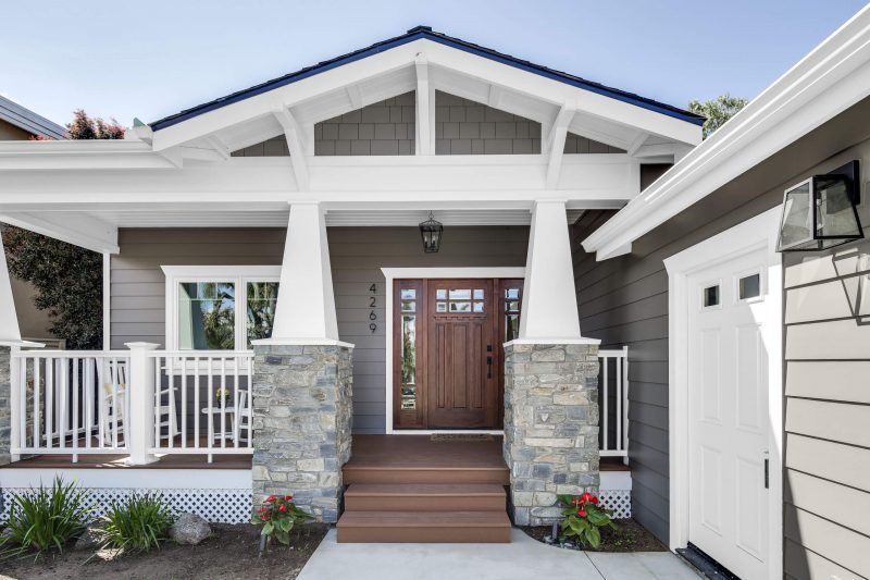 For the exterior, that meant adding post and rock details, wood siding, eaves and a new front porch