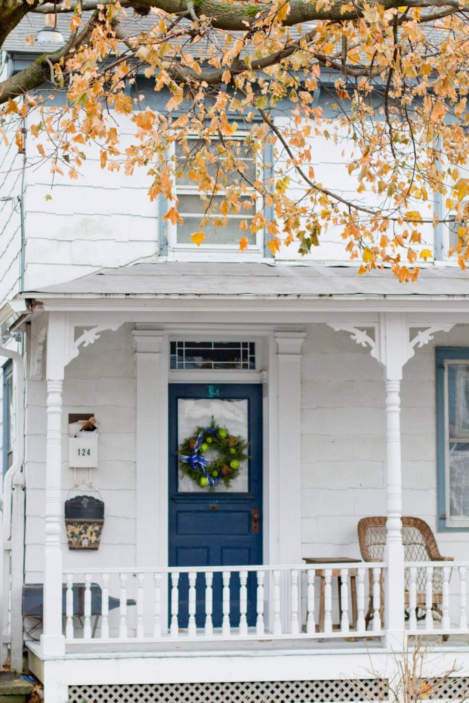 Green apples play off the deep blue color of this front door.