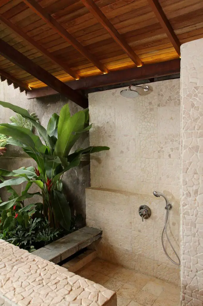 Semioutdoor shower room by Iwan Sastrawiguna Interior Design.