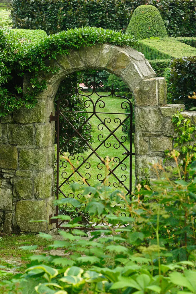 The iron gate and stone wall are original to this New York property, built in 1926.