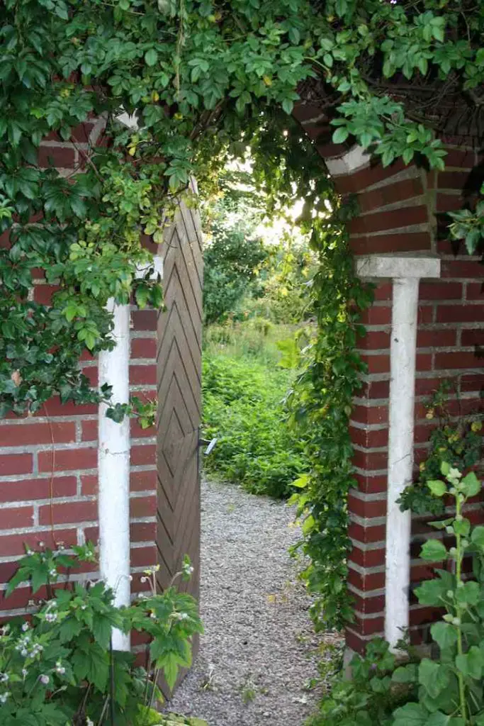 This Swedish country house near the town of Malmo includes a magical garden gate set in an old brick wall.