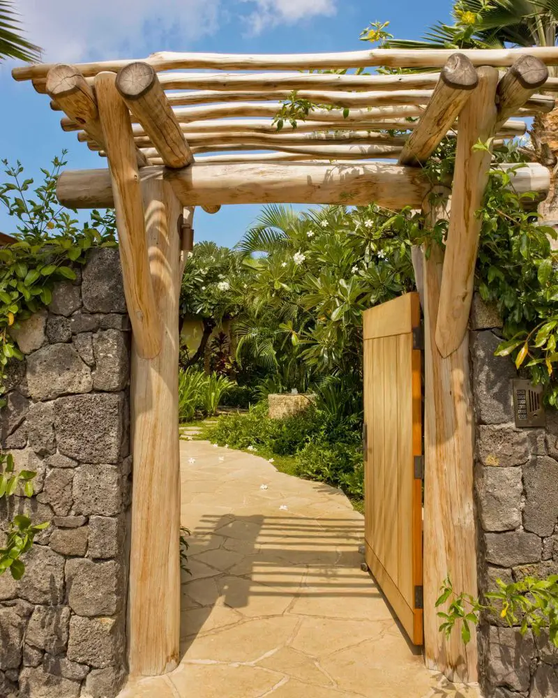 This simple and unadorned garden gate in Hawaii belies the glamour of the expansive estate and gardens beyond.