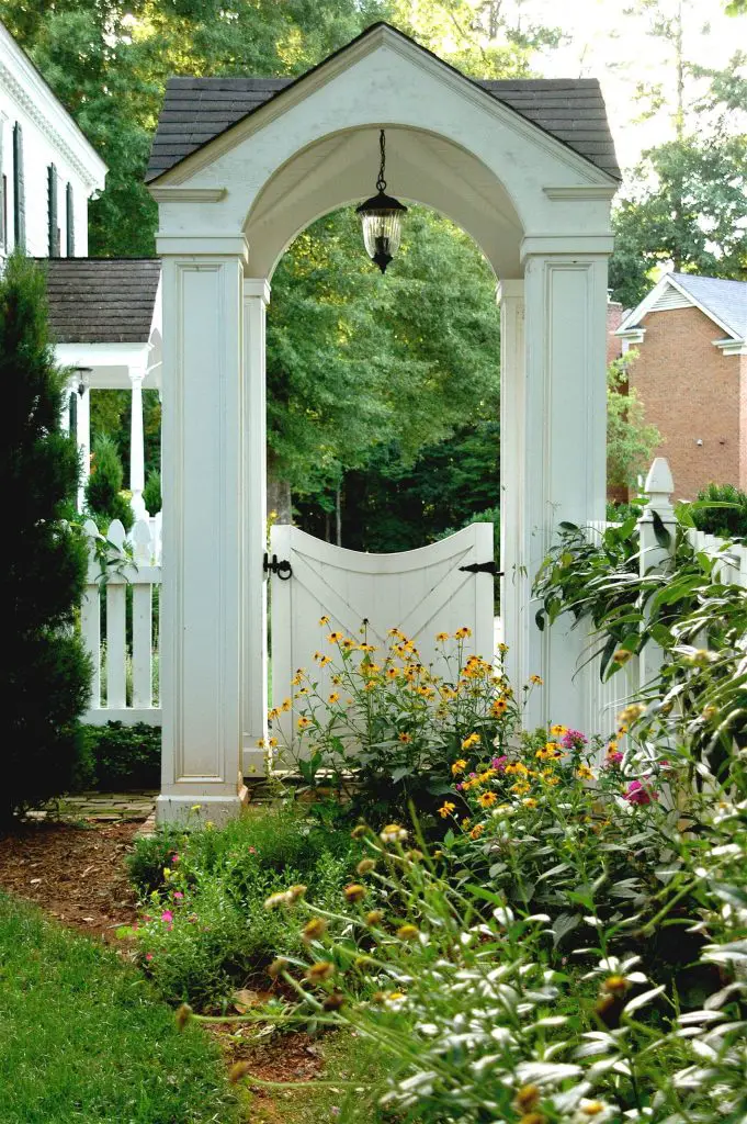This traditional white gate provides a formal entry in Williamsburg, Virginia.