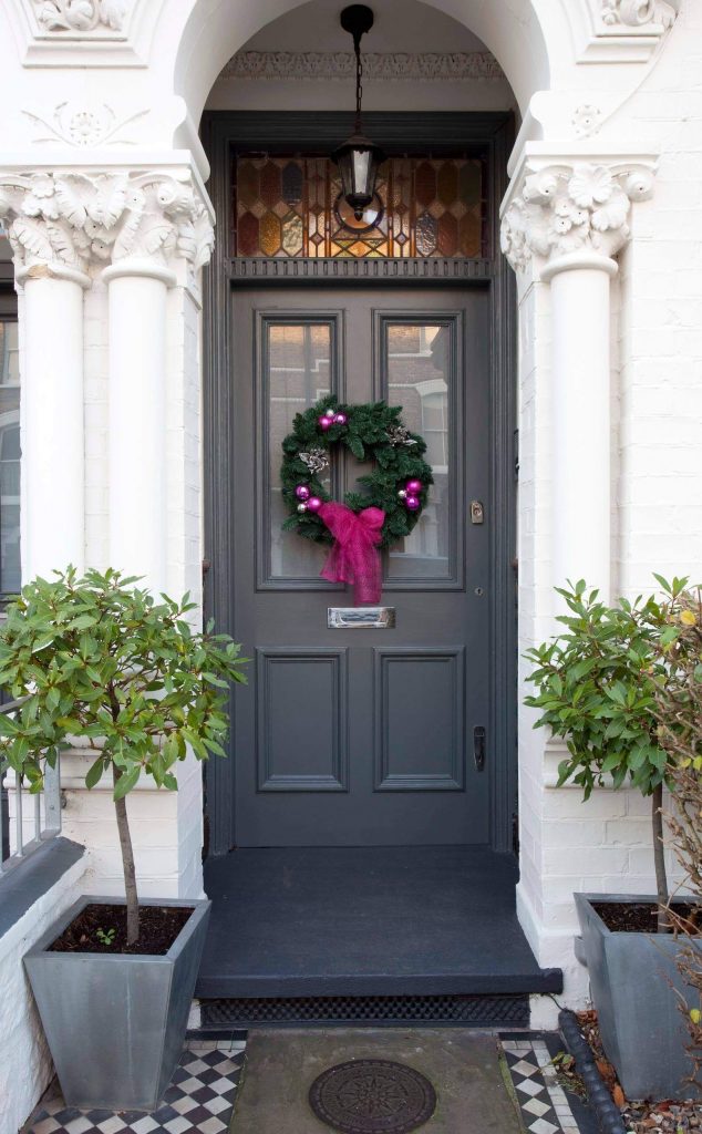 This wreath foreshadows the unexpected jewel toned holiday accents that await inside.