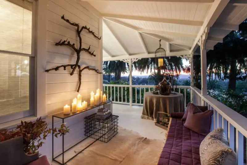 Cozy Up a Porch With Candles and Throws